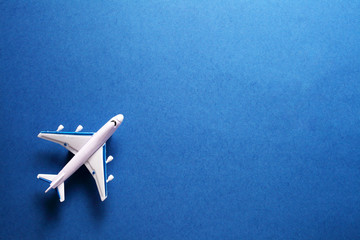 toy passenger plane on a blue background, top view with place for your text