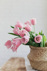 pink tulips at home on a wooden table