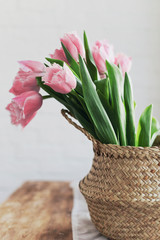 pink tulips at home on a wooden table