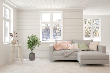 Modern living room in white color with sofa and winter landscape in window. Scandinavian interior design. 3D illustration