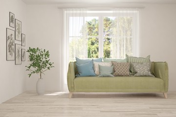 Minimalist living room in white color with sofa and summer landscape in window. Scandinavian interior design. 3D illustration
