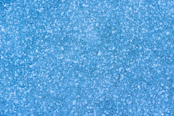 Fototapeta na wymiar blue texture of an snow surface with pure white wave , blue cold clear cryslallized wall background ,winter frozen lake side close up , abstract macro wallpaper