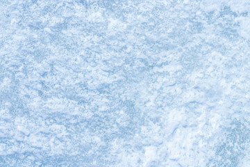 blue texture of an snow surface with pure white wave , blue cold clear cryslallized wall background ,winter frozen lake side close up , abstract macro wallpaper