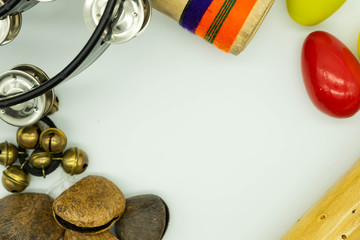 Top view of percussion instruments forming a frame on white background. Acoustic instruments concept.
