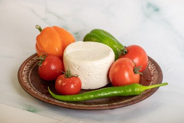 Cheese platter with tomatoes and chilies