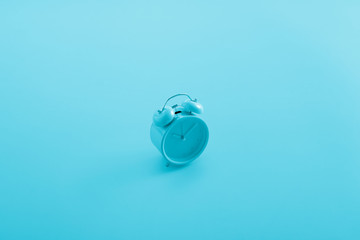 alarm clock in aqua blue background, minimalism, idea, conceptual images, can easily change the colour tone, and text as a design.