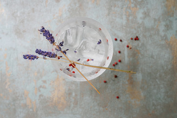 Alcohol beverage. Refreshing Gin and Tonic cocktail served with herbs, spicies and ice over the...