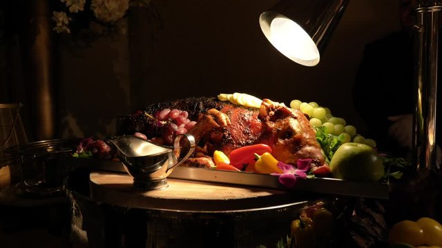 Slow move towards full roast pig on plate