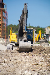 A large construction excavator of yellow color