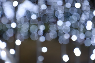 Diffused silver and white bokeh Black background at night