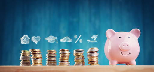 piggy bank with stacked coins on blue background
