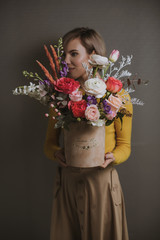young woman with bunch of flowers