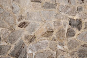 The wall is made of masonry cobblestones. part of the wall.