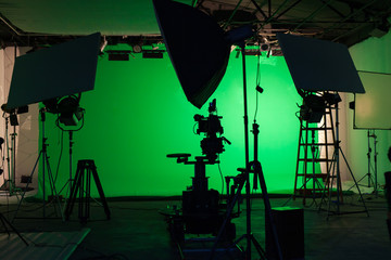 Shooting studio set with professional equipment and green screen