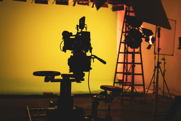 Shooting studio with professional equipment and yellow/green screen