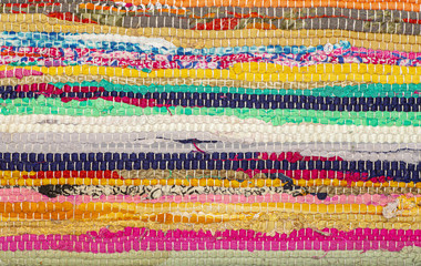 Boho carpet style. Colored carpet background. Handmade rug made from recycled fabric or clothing...