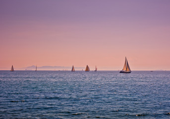 Calming view several boats at the sea at dusk or dawn