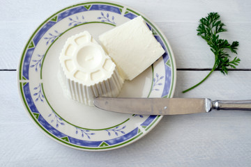 White cheese on plate and rustic wooden table