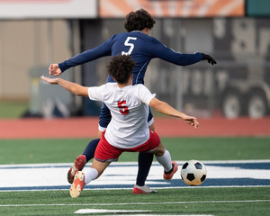 Boy Soccer Players making exciting plays during a soccer game