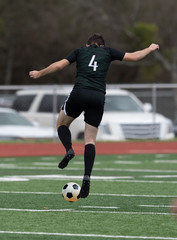 Obraz premium Boy Soccer Players making exciting plays during a soccer game
