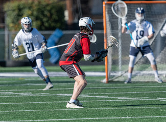 Young athletes making amazing plays while playing in a Lacrosse game