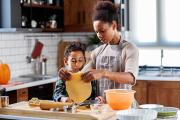 Mother with his son prepare pie in the kitchen