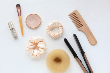 wooden Hairbrush, hair straightener and yellow silk Scrunchy on white. Flat lay Hairdressing tools and accessories as Color Hair Elastic HairBands, Scrunchies Hairband