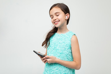 Naklejka premium young girl listens to music on headphones and relaxes on a white background