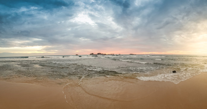 Panoramic image of beautiful cloudy sky on the sunset at ocean beach