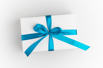 festive white gift box with blue bow