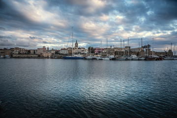 Obraz premium Dark clouds over Alghero at sunset