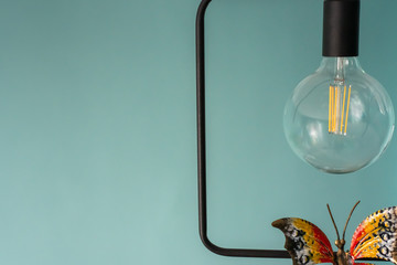 Light bulb with a metal butterfly. Loft style