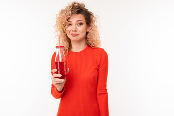 Beautiful caucasian woman drinks red juice