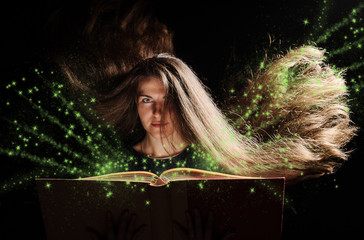 Magic Woman reading a book. black background