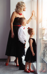 happy mother with children near the window