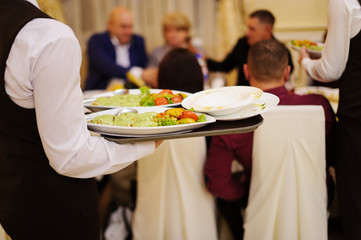 waiter with plate with food in the hands