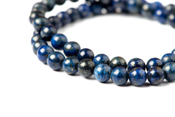 Lapis lazuli bracelet on a white background close-up. Lapis lazuli stone beads.