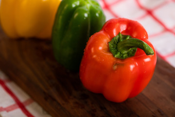 Bell peppers on a wooden cutting board