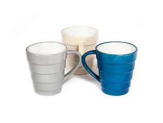 Three colorful mugs isolated on white background