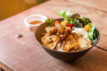 Steam rice with Chicken Satay and fried egg served with salad including green oak and tomato. Served with Satay sauce.