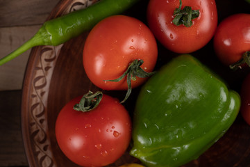 Red fresh tomatoes and a green pepper