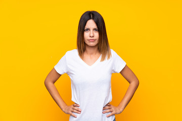 Obraz premium Young woman over isolated yellow background angry