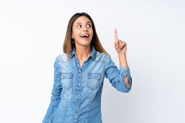 Young woman over isolated white background thinking an idea pointing the finger up