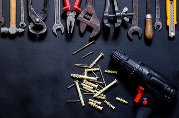 Obraz na płótnie Canvas Construction worker tools on a dark background top view.