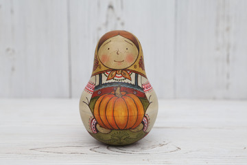 Russian traditional wooden nesting toy - matryoshka, nested doll in form of woman in national...