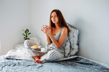 Woman having her breakfast in bed
