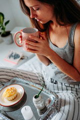 Woman having her breakfast in bed