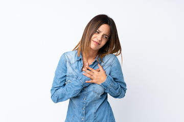 Young woman over isolated white background having a pain in the heart