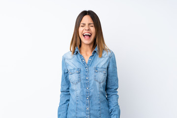 Young woman over isolated white background shouting to the front with mouth wide open