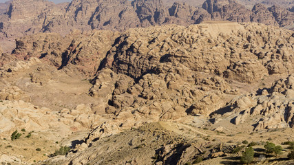 View of ancient Petra from above. Red mountains of Jordanian desert inside which ancient city Petra was carved into stone. Ecology and travel theme. There is place for your text. Petra, Jordan - 2011